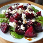 A vibrant Roasted Beet and Goat Cheese Salad with fresh greens and a balsamic glaze.