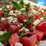 Close-up of a refreshing Watermelon Feta Salad with Mint, featuring cubed watermelon, crumbled feta cheese, and fresh mint leaves.