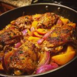 Close-up of Sweet Savory Peach Chicken Recipe cooked in a pan with peaches and red onions.