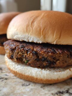 Close-up of a perfectly grilled, sturdy veggie burger patty served on a soft white bun.