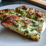Three slices of golden-crusted Garlic Herb Cheese Pizza topped with melted mozzarella and fresh green herbs.