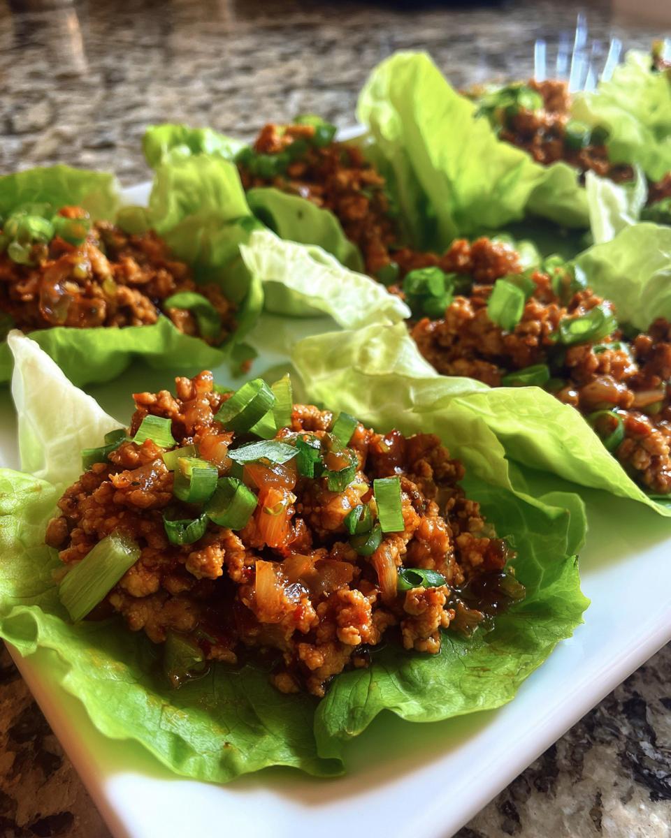Close-up of savory filling served in crisp lettuce cups, ready to eat Asian Lettuce Wraps.