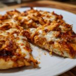 Close-up of slices of BBQ Chicken Flatbread Pizzas topped with melted, bubbly cheese and shredded chicken.