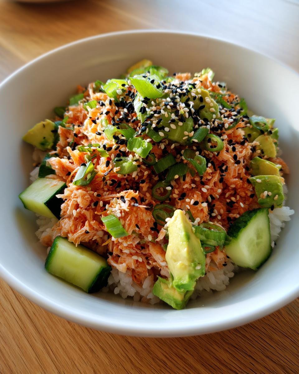 Close-up of California Roll Sushi Bowls featuring spicy salmon mix, avocado, cucumber, masago, and sesame seeds.