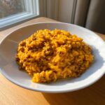 A close-up serving of creamy, cheesy Cheeseburger Orzo mixed with ground beef in a white bowl.