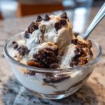 Close-up of Chocolate Chip Cookie Dough Yogurt Delight scoops topped with mini chocolate chips.