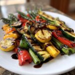 A vibrant Grilled Veggie Platter With Balsamic Drizzle featuring grilled zucchini, yellow squash, peppers, and asparagus.