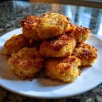 A pile of golden brown, crispy Hidden Veggie Chicken Nuggets stacked on a white plate.