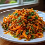 Close-up of vibrant Moroccan Spiced Carrot Lentil Salad with shredded carrots, lentils, and parsley.