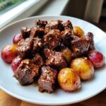 Mouthwatering Slow Cooker Garlic Butter Beef Bites Potatoes served in a white bowl.