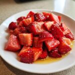 Close-up of chopped strawberries and watermelon tossed in a glistening Lime Honey Dressing.